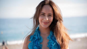 Leila Eguino MFA 28 IL in a blue top by the water