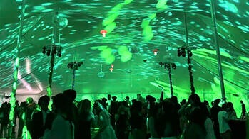 students dancing under green lights