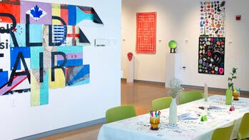 wall-mounted printed matter and a long dining table inside an art gallery
