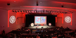 RISD Auditorium stage in intense red lighting