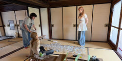 Students lay out glass on a floor 
