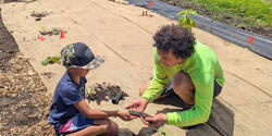 RISD student works with a young camper in Hawaii