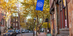Benefit Street in autumn with blue RISD flag