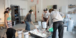 a group mixes brick dust into lime putty