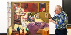 Professor Tom Roberts examines a student painting focused on propaganda