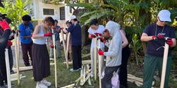 students extracting fiber out of banana plant's stems
