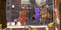 students crossing the canal on RISD's campus