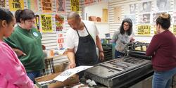 Printmaker and educator Jacques Bidon works with a group of art teachers in his printing studio