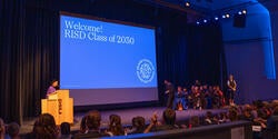 risd convocation ceremony with a sign welcoming the new class 