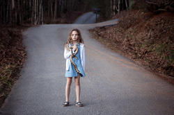 Photo of girl holding snake by Jennifer Garza-Cuen MFA 12 PH from her series Imag[in]ing America