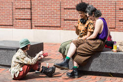 Students sit outside in Market Square, on RISD's campus.