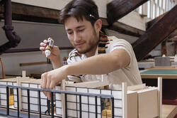 Architecture student Rubelcy Herrera works on a model