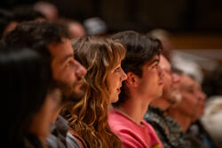 A group of people are listening at an event in RISD auditorium.