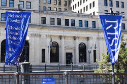 RISD blue flags flapping in the wind