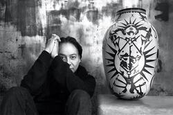 the artist poses with a piece