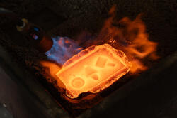 hot molten glass after it has been poured into a sand cast in the Hot Shop