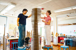 students work together on tall cardboard model