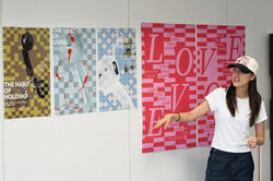 a student presents a three-poster series in crit