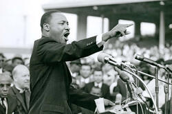 image of MLK Jr speaking in front of old-fashioned microphones