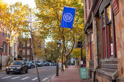 Benefit Street in autumn with blue RISD flag
