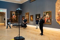 the class listens to student compositions inside the Grand Gallery