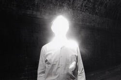 photo of a man with a head made out of bright light