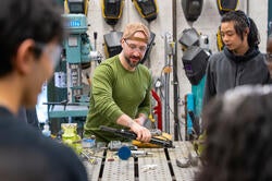 Matt Cavallaro shows students how to use the needle scaler
