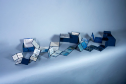 a cube that folds out into square pages of a book