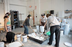 a group mixes brick dust into lime putty