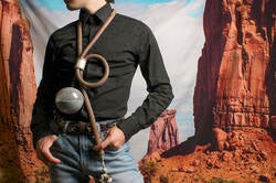the artist models a conceptual bolo tie incorporating rubber tubing and an avocado pit