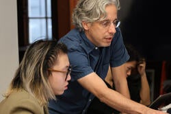 RISD faculty member Daniel Lefcourt works with a student on a computer-based project