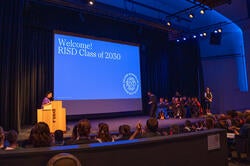 risd convocation ceremony with a sign welcoming the new class 