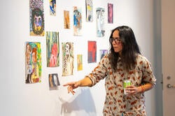 visiting scholar Mala Iqbal presents a wall of small drawings