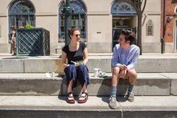 Students sitting and talking on River Walk steps
