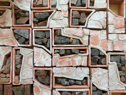 detail of assembled blocks of repurposed stones and red brick