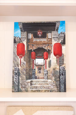 a mounted image of an entryway in a traditional Chinese architectural style, including hanging red lanterns