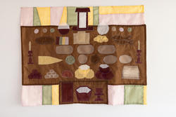 a brown tapestry with sewn-on shapes resembling tableware