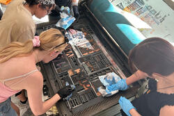 Students preparing type for the first communal print on the giant Seraglio press