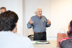 David Rothstein speaks to a classroom of students