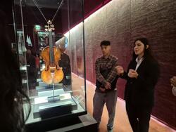 A student views a violin in a museum