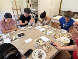 students paint on a table