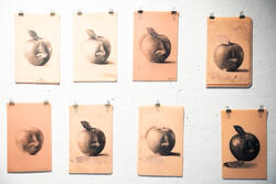 Tattoo work of a nose coming out of an apple