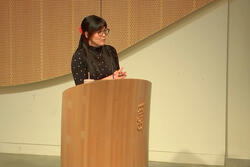 A person stands at a risd podium