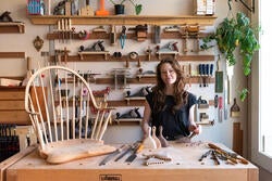 Aspen Golann in front of her tool wall in her studio