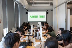 students at a table with the word playtest time on a screen