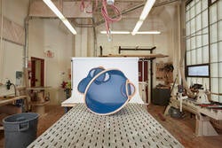 A round piece of furniture on display in a fabrication shop