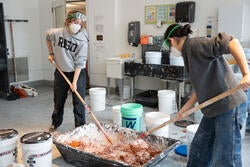 a group mixes brick dust into lime putty