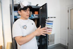 a man holds containers of pigment 