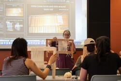 a professor demonstrates weaving