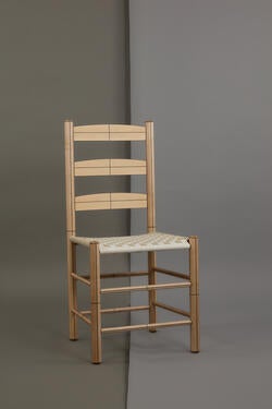 a light-brown wood chair with three horizontal support slats on the chair back, in the Shaker style
